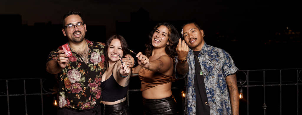 Friends hanging out together on a rooftop, smiling for the camera and enjoying Fernway Golden Tiger sativa vape cartridges.